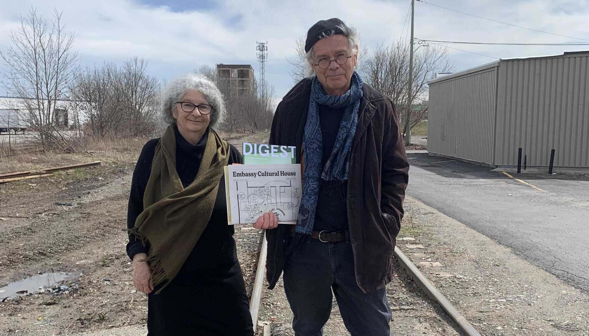 Jamelie Hassan and Ron Benner stand outside the gallery on the train tracks