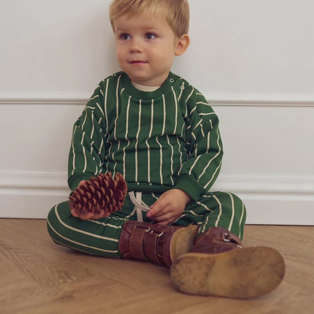 baby wearing cute green stripped t-shirt with matching stripped paints 
