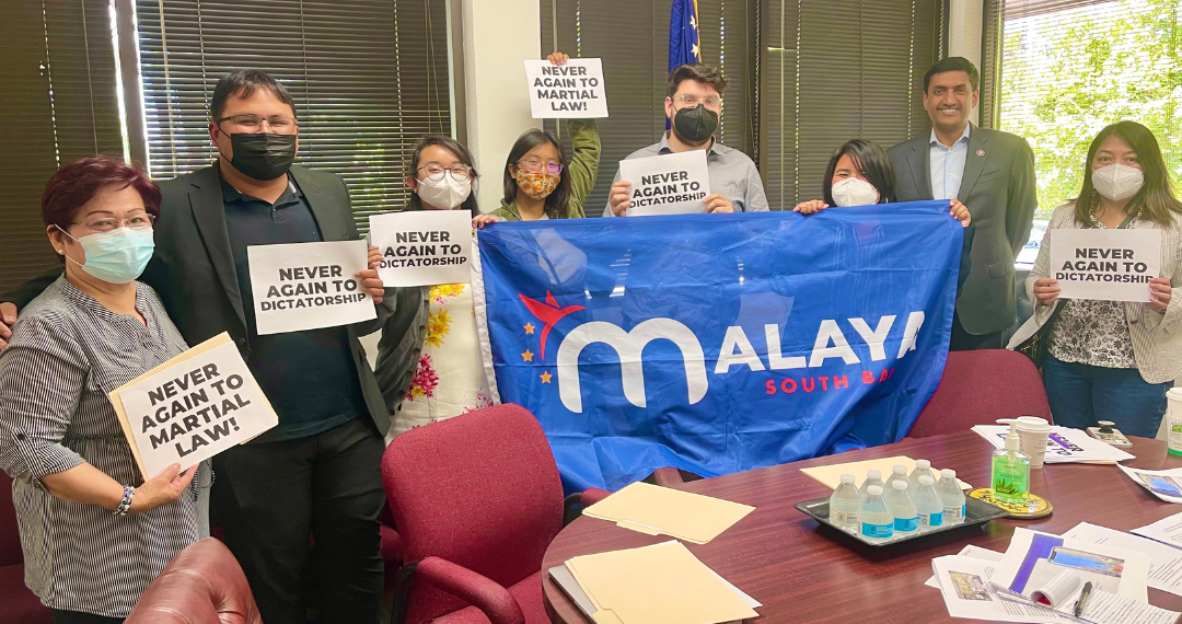 Image of 8 people holding up a banner that says Malaya South Bay and several papers that say "never again to martial law"