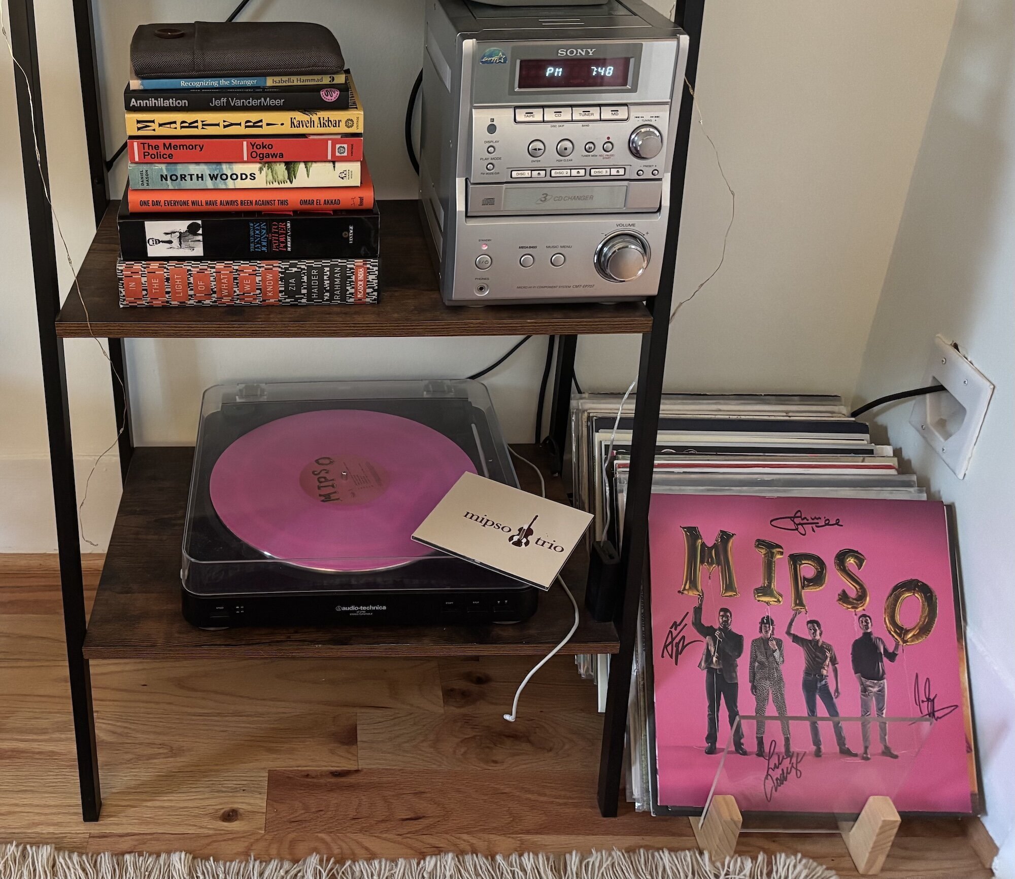 A music set up, with a record player and cd player, both showing mipso albums