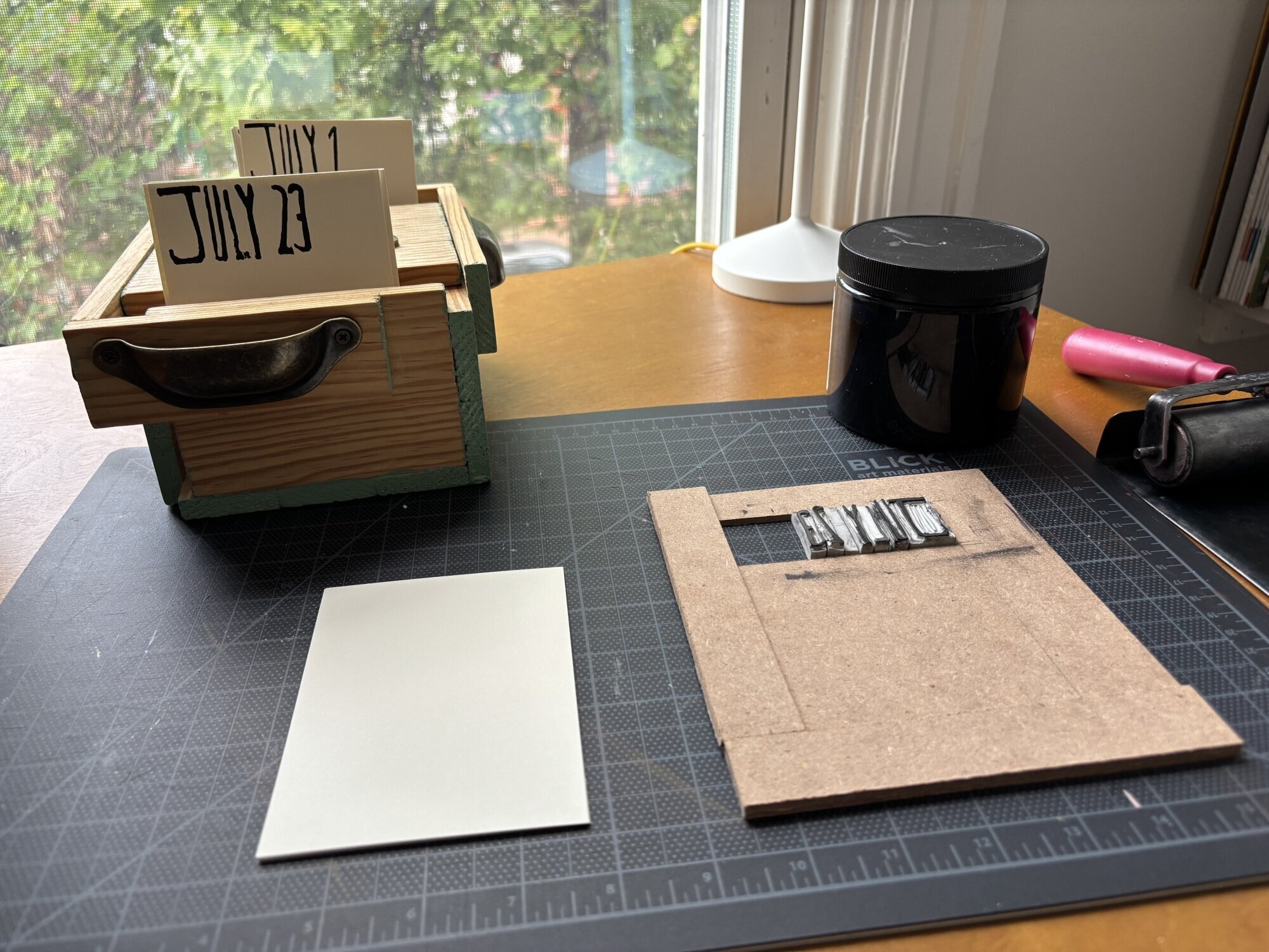 A set up for printing a perpetual calendar, including the box it'll be housed in. 